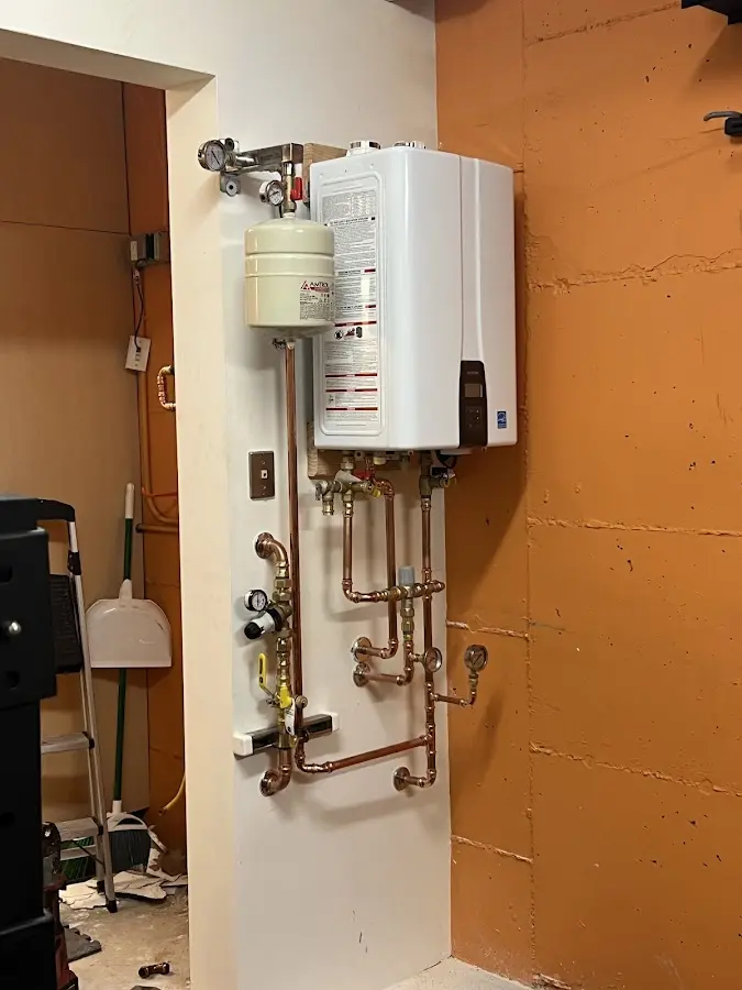 Plumbing technician inspecting water heater connections in Boca Raton